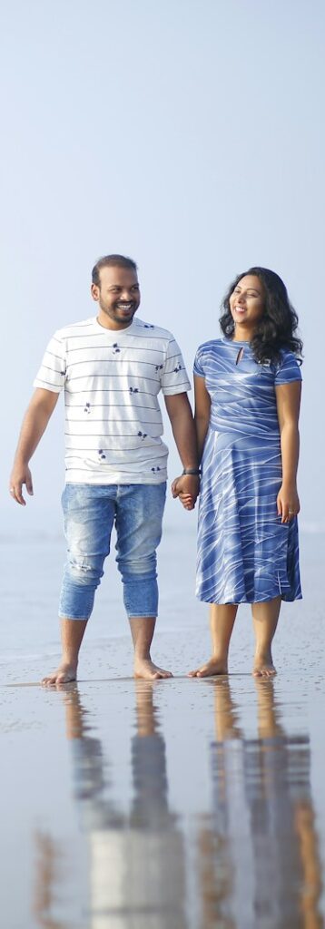 couple holding hands near shore